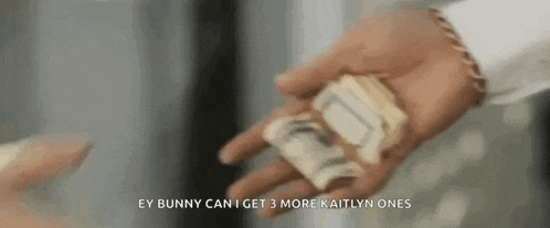 a person is holding a bunch of money in their hand and giving it to another person .
