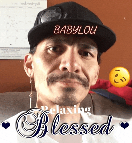 a man wearing a hat with babylou written on it