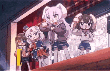 a group of anime girls are standing on a stage with one holding a microphone .