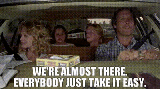 a family is sitting in a car with the words " we 're almost there everybody just take it easy "