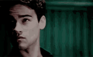 a close up of a young man 's face with his eyes closed .