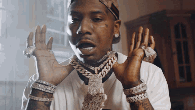 a man wearing a chain around his neck and many bracelets