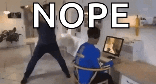 a man in a blue shirt is standing in front of a computer screen with the word nope written above him .