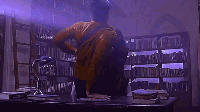 a man and a woman are hugging in a dark room with purple lights .