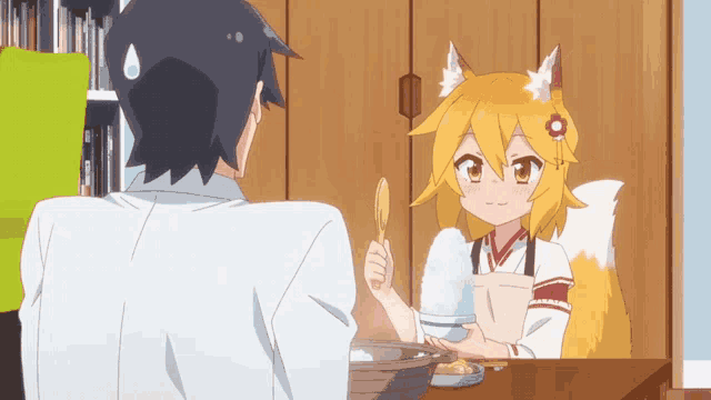 a man and a girl are sitting at a table and the girl is holding a bowl of rice