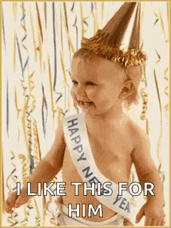a baby wearing a party hat and a happy new year sash is smiling .