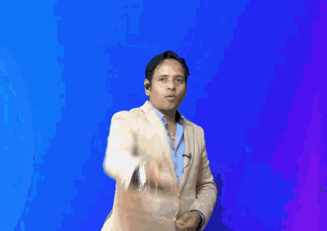 a man in a suit is dancing in front of a blue welcome sign