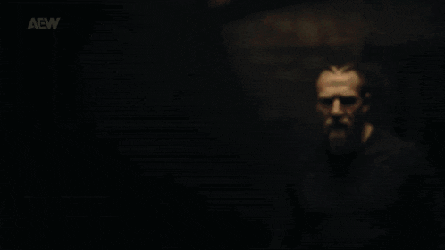 a man with a beard is wearing a black shirt that says aow on it