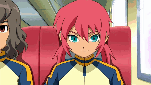 a girl with pink hair and blue eyes is sitting in a red chair