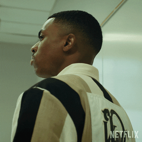 a man is wearing a striped shirt with a netflix logo on the back