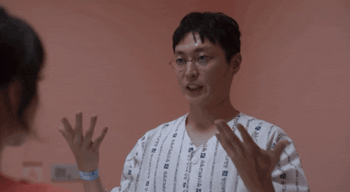 a man in a hospital gown with chinese writing