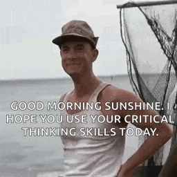a man wearing a hat and a tank top is standing in front of a boat in the water .