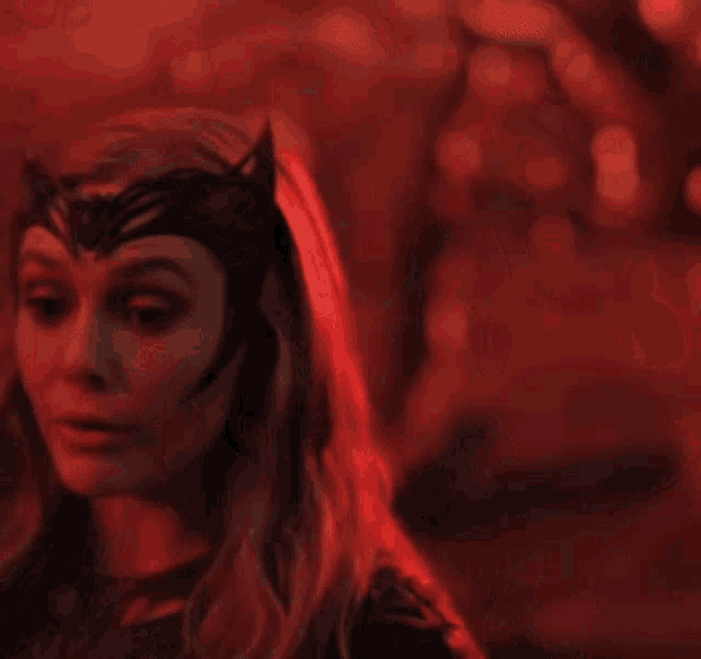 a close up of a woman wearing a mask with horns on it