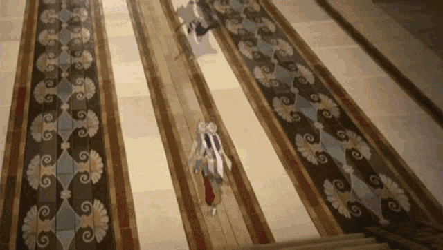 a couple of people are walking down a hallway with a floral pattern on the floor .