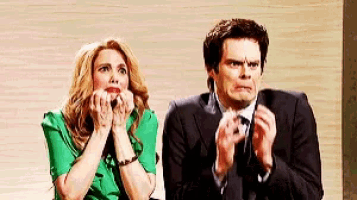 a man and a woman are sitting next to each other and the woman is wearing a green shirt .