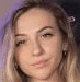 a close up of a woman 's face with a purple background and a blurred background .
