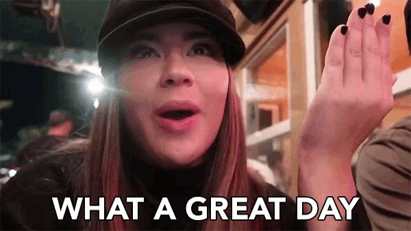 a woman in a hat is saying what a great day while waving her hand .