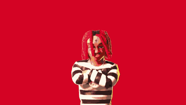 a person with red hair and dreadlocks is holding a microphone in front of a fire explosion .