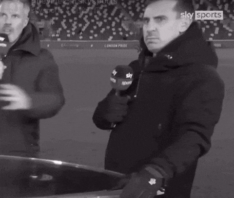 a man holding a microphone with the word sky sports on it
