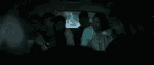 a group of people are sitting in a car with the words `` wordness to the turdness '' written above them .