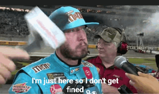 a man in a m & m 's hat is being interviewed