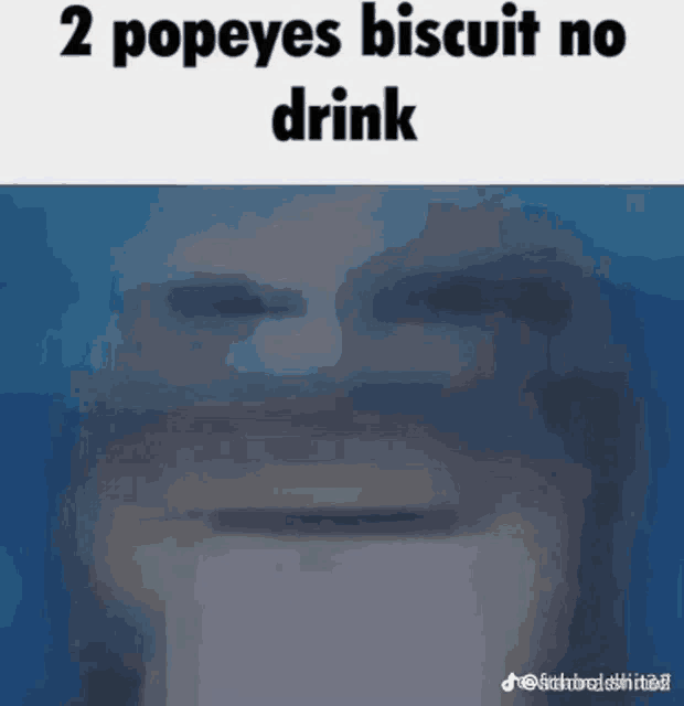 a man is drinking a popeye 's biscuit from a cup .