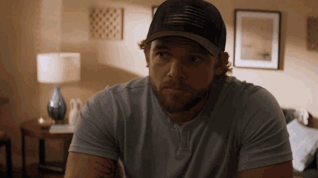 a man with a beard wearing a baseball cap