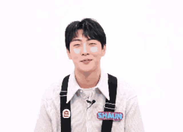 a young man wearing suspenders and a shirt that says ' chunin ' on it