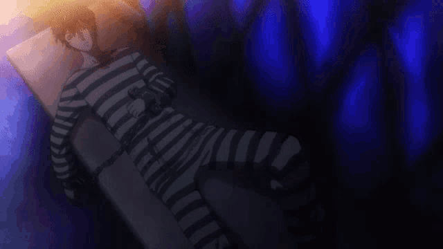 a person in striped pants is laying on a bed
