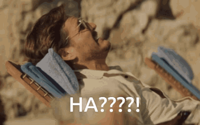 a man is laying in a chair with the word ha on the bottom right