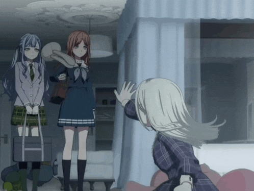 three anime girls are standing in a room and one of them is holding a stuffed animal
