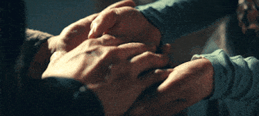 a group of people holding hands with one wearing a wedding ring