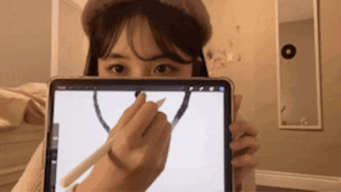 a woman is holding a tablet with a pen in her hand
