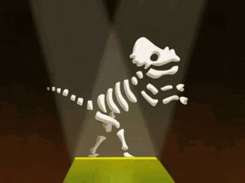 a skeleton of a dinosaur is displayed in a spotlight