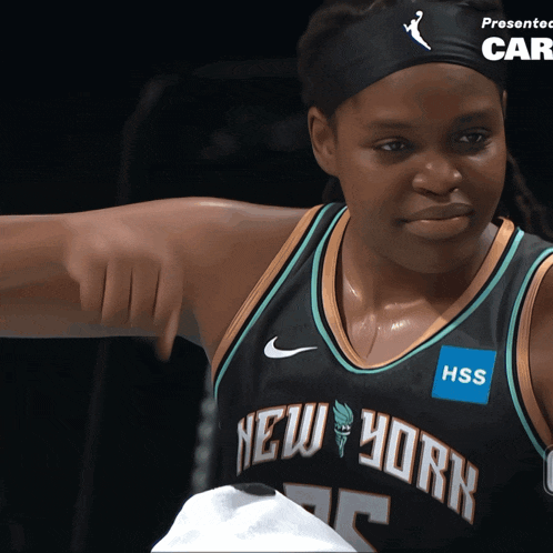 a woman wearing a new york jersey with a hss sticker on her chest