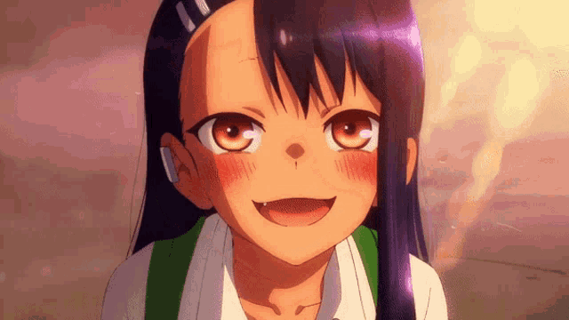 a close up of a girl 's face with a smile