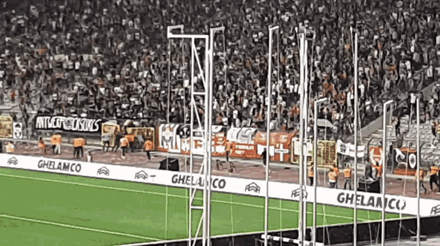 a soccer stadium with a banner that says ghelamco