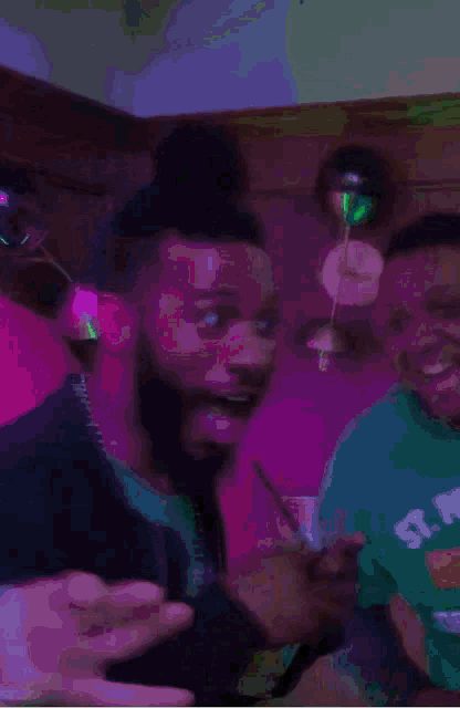 a man with a bun on his head is holding a shot glass in his hand