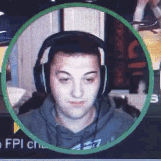 a man wearing headphones is sitting in a green circle on a computer screen .