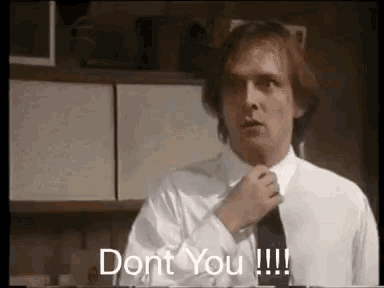 a man in a white shirt and tie is adjusting his tie and says `` dont you !!! '' .