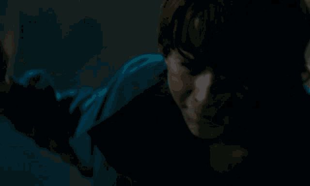 a close up of a person laying on the ground with their head down