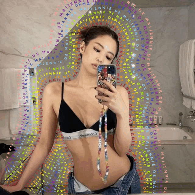 a woman in a calvin klein bra takes a picture of herself in a mirror