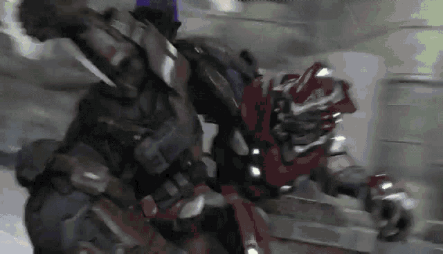 a close up of a person in a robot costume fighting another person .