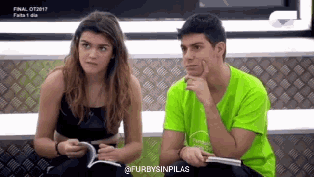 a man and a woman are sitting next to each other and the man is wearing a green shirt