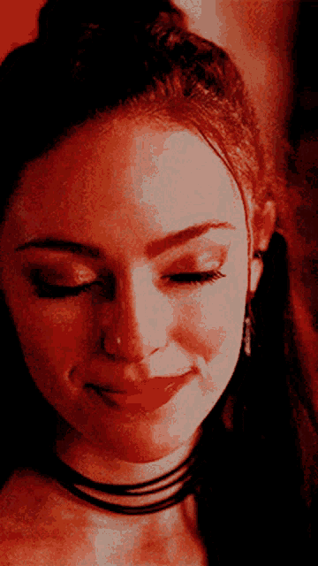 a close up of a woman 's face with her eyes closed and red lips