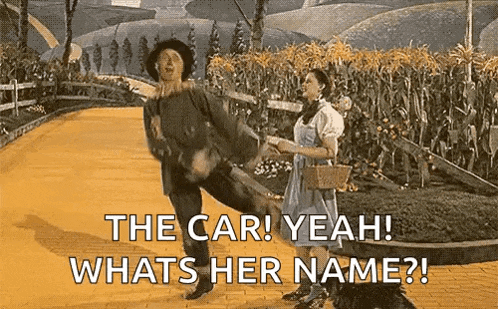 a man and a woman are standing next to each other on a dirt road .