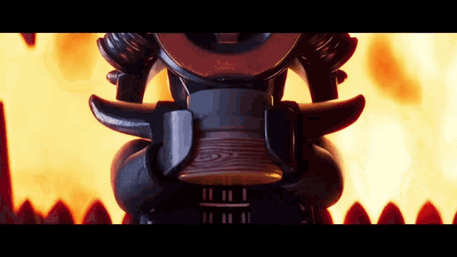 a close up of a samurai figurine with flames behind him