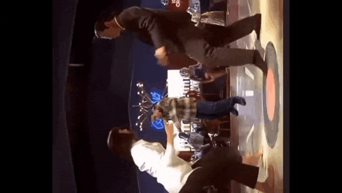 a man and a woman are dancing on a stage in a club .