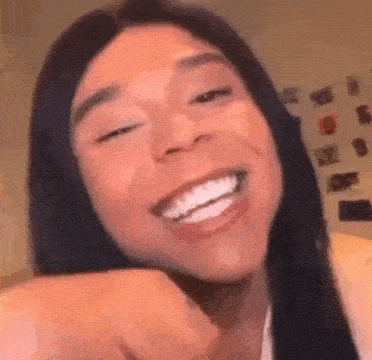 a close up of a woman 's face with a huge smile on her face .