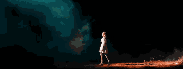 a woman in a white dress is standing in a dark room with smoke behind her
